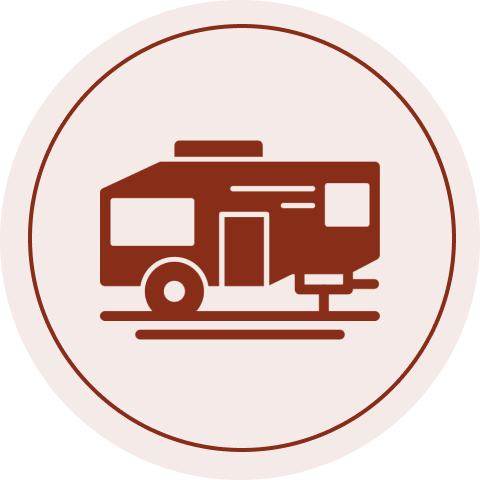 Camper trailer icon in circular frame.