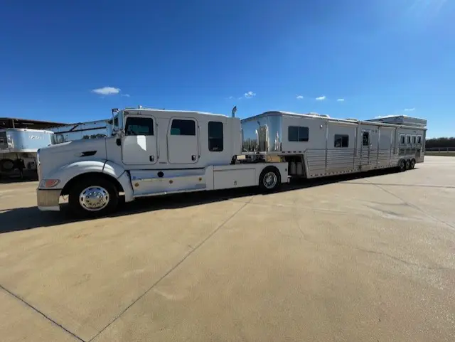 A large white semi-truck with an extended trailer on a sunny day.